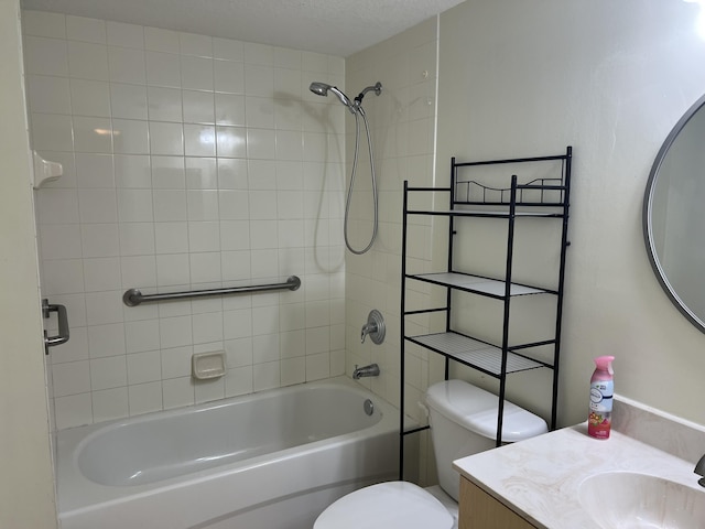 full bathroom with vanity, tiled shower / bath combo, and toilet