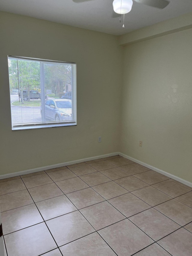 spare room featuring ceiling fan and light tile patterned floors