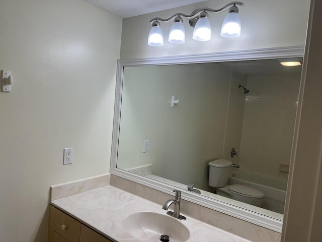 full bathroom featuring tiled shower / bath combo, toilet, and vanity