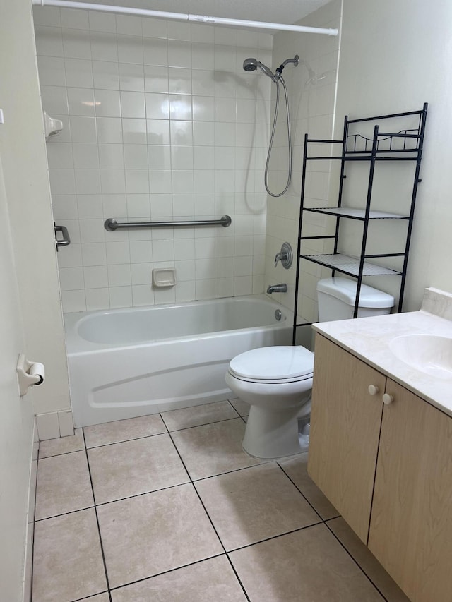 full bathroom featuring tile patterned flooring, vanity, tiled shower / bath combo, and toilet