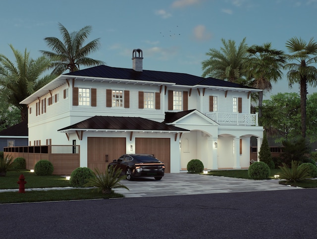 view of front facade featuring a garage and a balcony