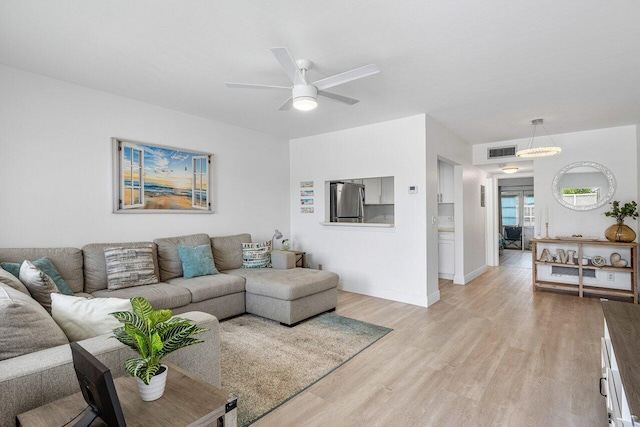 living room featuring ceiling fan and light wood-type flooring