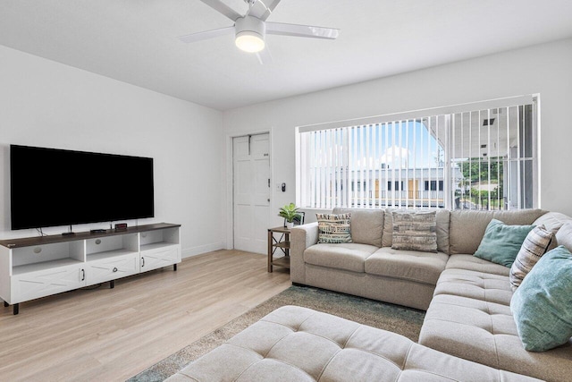 living room featuring ceiling fan and light hardwood / wood-style floors