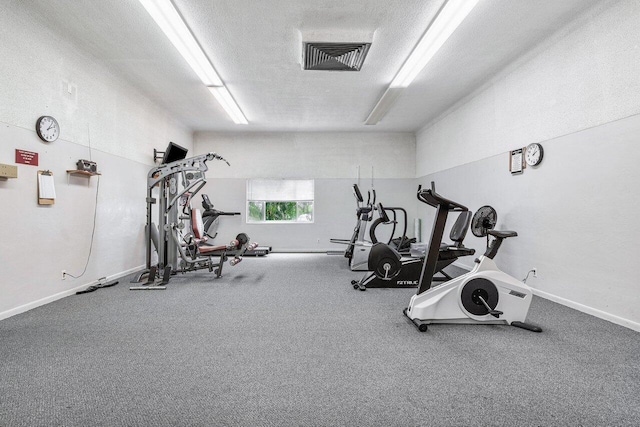 exercise room with a textured ceiling