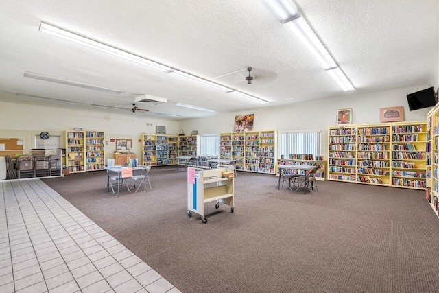 misc room featuring light carpet and a textured ceiling