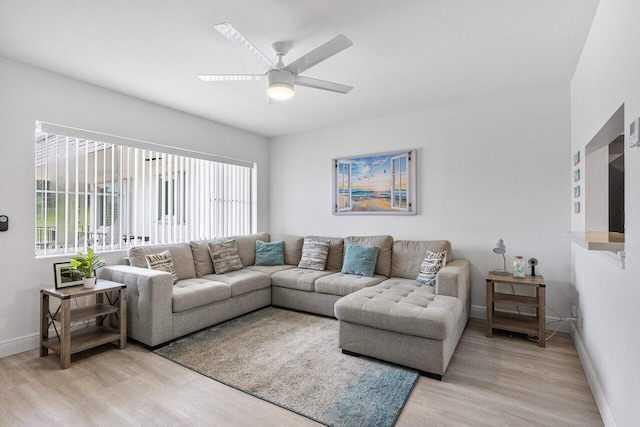 living room with ceiling fan and light hardwood / wood-style floors