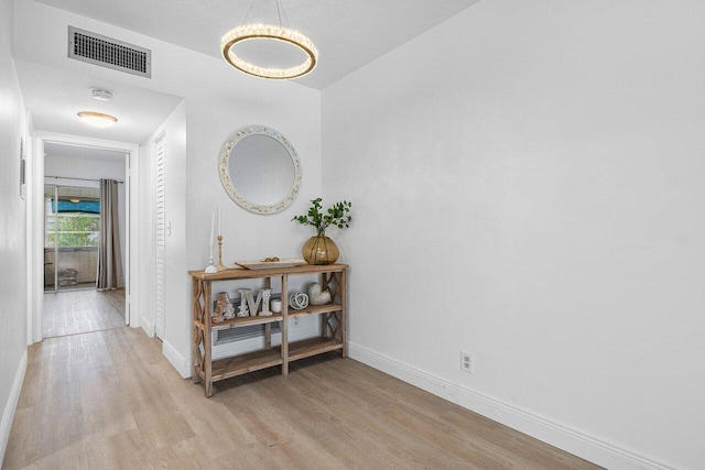 corridor featuring light hardwood / wood-style floors