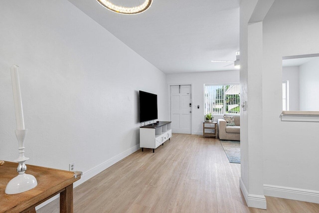 living room featuring light hardwood / wood-style floors and ceiling fan