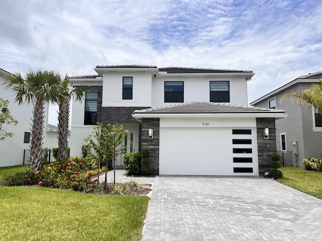 view of front facade with a front yard and a garage