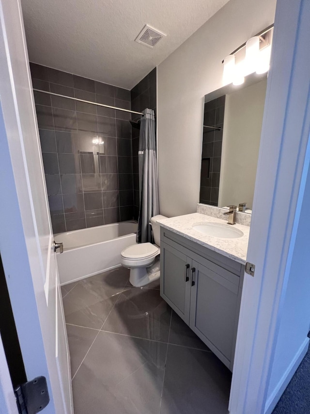 full bathroom with vanity, tile patterned floors, toilet, shower / bathtub combination with curtain, and a textured ceiling