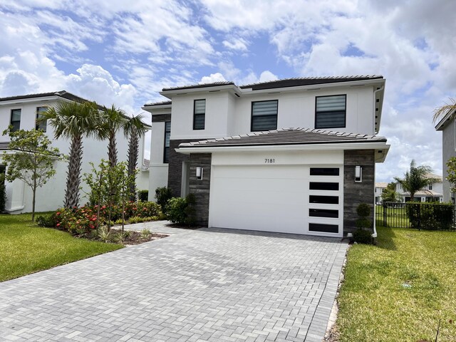 view of front of home featuring a garage and a front yard