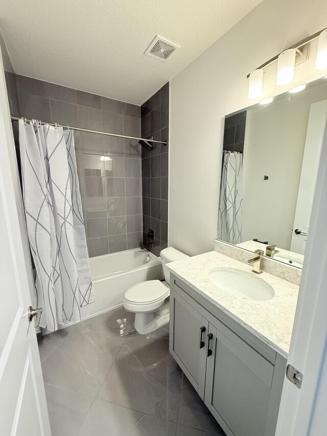 bathroom with tile patterned floors, vanity, and a tile shower