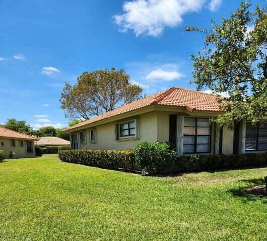 view of side of property with a lawn