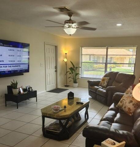 living room featuring ceiling fan and light tile patterned floors