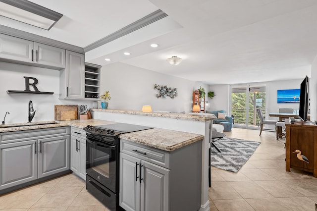 kitchen featuring sink, kitchen peninsula, black electric range, and gray cabinetry