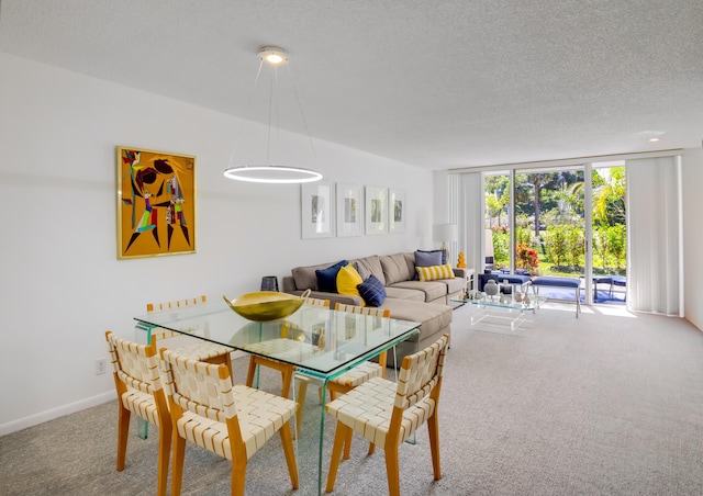 carpeted dining room with a textured ceiling and a wall of windows