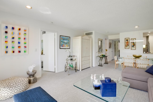 carpeted living room with a textured ceiling