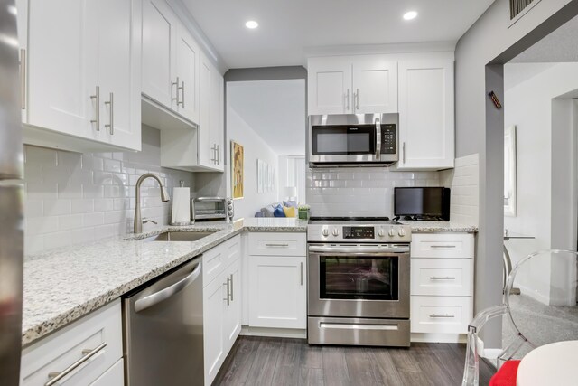 kitchen featuring white cabinets, stainless steel appliances, and sink