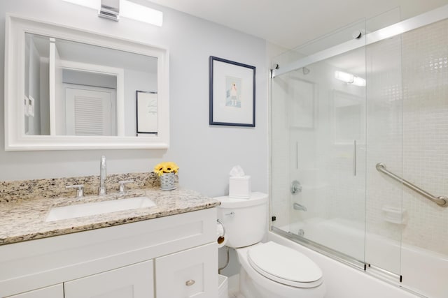 full bathroom with vanity, toilet, and bath / shower combo with glass door