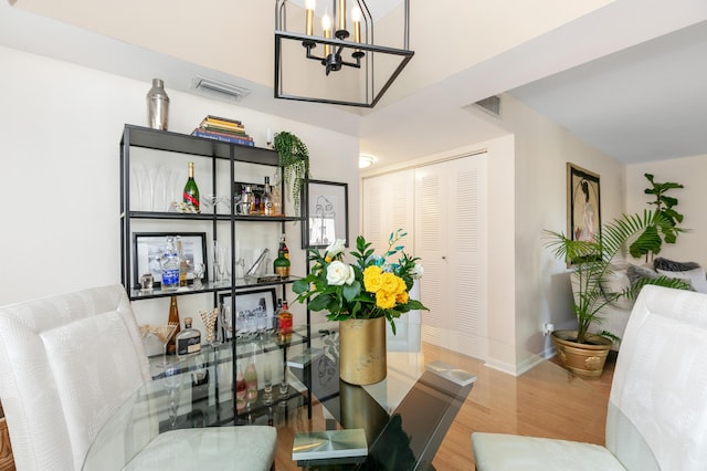 dining room with an inviting chandelier and hardwood / wood-style floors