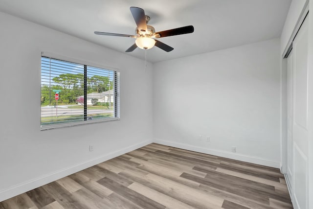 spare room featuring ceiling fan and light hardwood / wood-style flooring