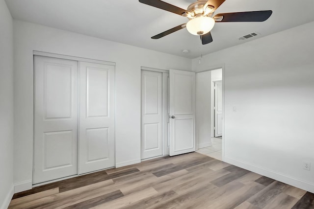 unfurnished bedroom with ceiling fan and light hardwood / wood-style floors