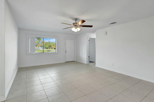 spare room with ceiling fan and light tile patterned floors