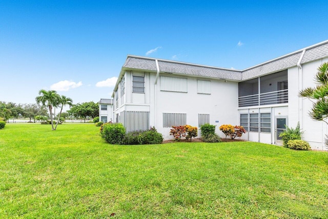 view of property exterior with a lawn