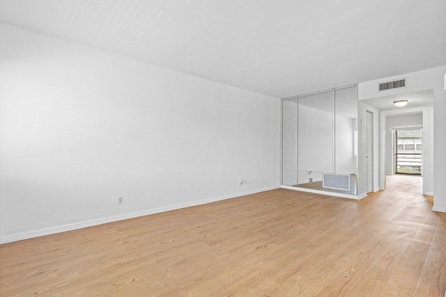 spare room featuring light hardwood / wood-style flooring