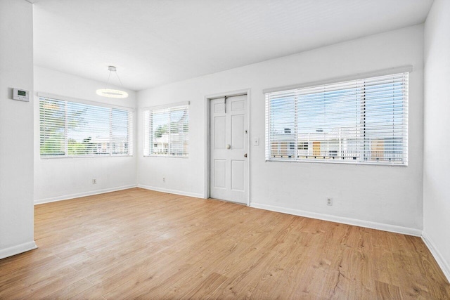 unfurnished room with light wood-type flooring