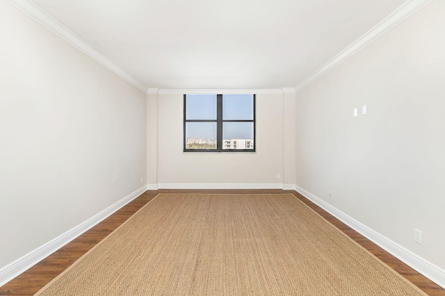 empty room featuring wood-type flooring and crown molding