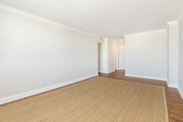 spare room featuring hardwood / wood-style floors and ornamental molding