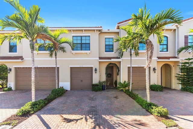 mediterranean / spanish home featuring a garage