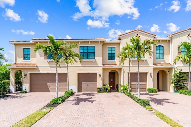 mediterranean / spanish-style home with a garage