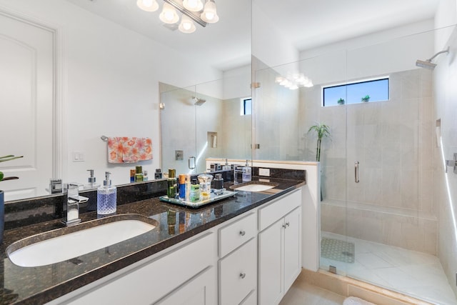 bathroom featuring vanity and a shower with door