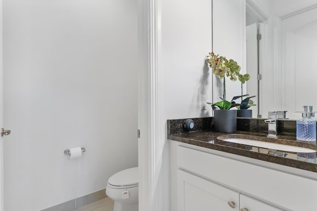 bathroom featuring tile patterned floors, vanity, and toilet