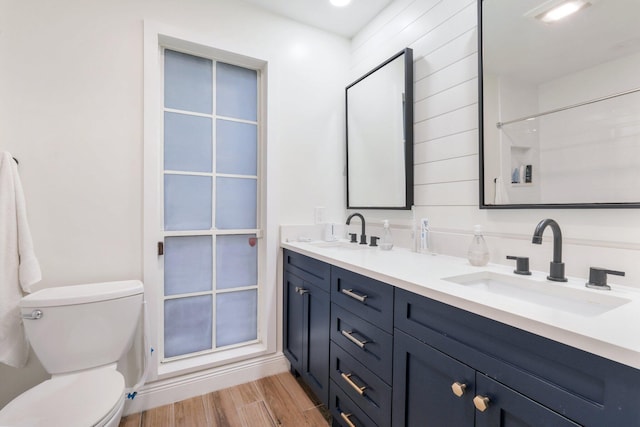 bathroom featuring hardwood / wood-style floors, vanity, and toilet