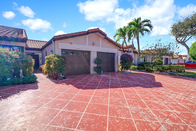 mediterranean / spanish house with a garage