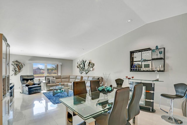 dining space featuring vaulted ceiling