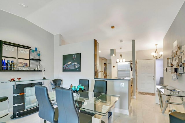 tiled dining space with lofted ceiling and an inviting chandelier