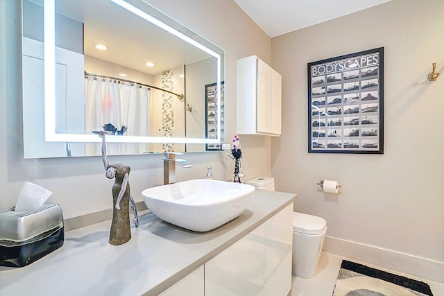 bathroom featuring toilet, tile patterned floors, walk in shower, and vanity