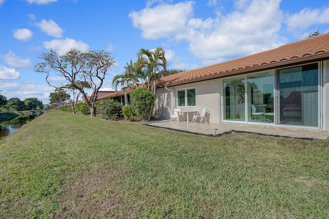 6140 Kings Gate Cir, Delray Beach, FL 33484 - back of house with a tiled roof, a lawn, a patio area, and stucco siding