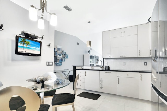 6140 Kings Gate Cir, Delray Beach, FL 33484 - kitchen featuring dark countertops, backsplash, light tile patterned flooring, pendant lighting, and high quality fridge