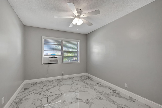 unfurnished room with ceiling fan, cooling unit, and a textured ceiling