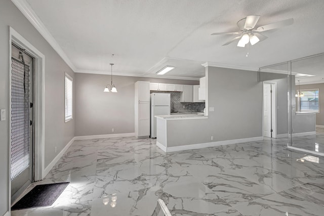 unfurnished living room featuring a textured ceiling, crown molding, and ceiling fan with notable chandelier