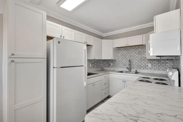 kitchen featuring white cabinets, white appliances, sink, and tasteful backsplash