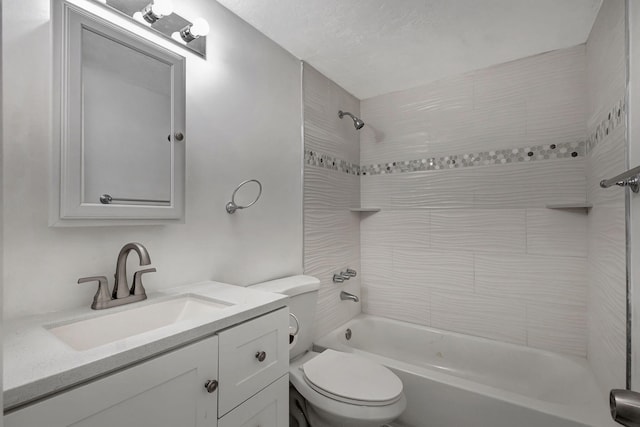 full bathroom featuring vanity, toilet, and tiled shower / bath