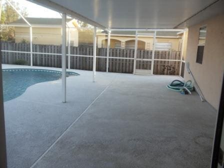 view of pool featuring a lanai and a patio