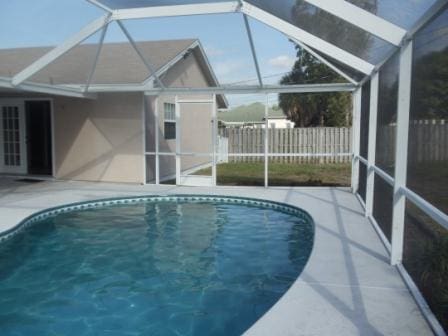 view of pool with a lanai and a patio area