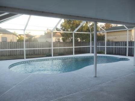 view of pool with a patio area and a lanai